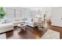Bright living room with hardwood floors, white sectional sofa, and large windows bringing in natural light at 2110 Winter St, Charlotte, NC 28205