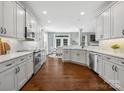 Modern kitchen with white cabinets, stainless steel appliances, hardwood floors, and a breakfast area at 2467 Chatham Dr, Fort Mill, SC 29707