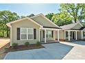 Charming home exterior showcasing green siding, black shutters, and a well-maintained yard at 2502-2504 Glendale Ave, Kannapolis, NC 28081
