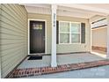 Inviting front porch with brick accents, black door, and visible house number: 2504 at 2502-2504 Glendale Ave, Kannapolis, NC 28081