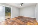 A bright bedroom with wood floors and sliding glass doors leading to a private deck, perfect for relaxation at 2603 Mary Ave, Gastonia, NC 28052
