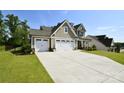 Two-story home with a well-manicured lawn and a spacious driveway leading to an attached two-car garage at 262 Country Lake Dr, Mooresville, NC 28115