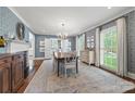 Elegant dining room with decorative wallpaper, hardwood floors, chandelier, and natural light from the windows at 2900 Wickersham Rd, Charlotte, NC 28211