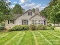Well-maintained lawn and landscaping complement the exterior of this inviting home at 3128 Country Club Dr, Charlotte, NC 28205