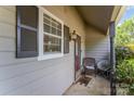 Inviting covered porch with wicker chair and outdoor lighting, great for enjoying a peaceful evening at 3131 Heathstead Pl, Charlotte, NC 28210