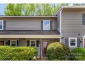Two-story townhouse featuring a cozy front porch and well-kept landscaping at 3131 Heathstead Pl, Charlotte, NC 28210