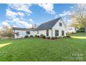 Beautiful exterior showcasing the well-manicured lawn, fresh landscaping and design of this charming home at 317 Commodore Loop, Mooresville, NC 28117