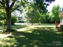 Expansive backyard featuring mature trees, lush green grass, and an abundance of natural shade at 44716 Gold Branch Rd, Richfield, NC 28137