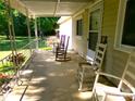 Inviting covered porch with multiple rocking chairs, perfect for relaxing and enjoying the outdoors at 44716 Gold Branch Rd, Richfield, NC 28137