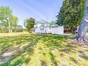 Exterior view of the two-story home surrounded by a large green lawn and mature trees at 4815 Nc 109 Hwy, Wadesboro, NC 28170