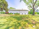 Large garage on a lush green lawn with mature trees in the background at 4815 Nc 109 Hwy, Wadesboro, NC 28170