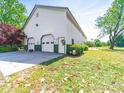 Large garage with three bays, green trim and well-manicured landscaping at 4815 Nc 109 Hwy, Wadesboro, NC 28170