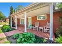 Inviting covered front porch featuring rocking chairs and brick flooring, perfect for relaxing outdoors at 539 30Th Nw Ave, Hickory, NC 28601