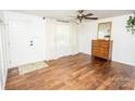 Bright living room featuring hardwood floors, a ceiling fan, and a front door entrance at 539 30Th Nw Ave, Hickory, NC 28601