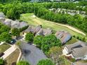 Beautiful aerial view of a neighborhood nestled amongst lush green trees adjacent to a golf course at 54053 Flycatchers Ct, Fort Mill, SC 29707
