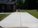 Large concrete driveway leading to the house at 556 Roundtree Cir, Chester, SC 29706