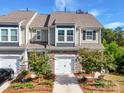 Charming townhome featuring stone accents, a one-car garage, and well-maintained landscaping at 574 Altamonte Dr, Clover, SC 29710
