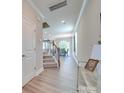 Inviting hallway with wood floors, staircase, neutral paint, and an elegant console table at 574 Altamonte Dr, Clover, SC 29710