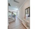 Inviting hallway with wood floors, staircase, neutral paint, and an elegant console table at 574 Altamonte Dr, Clover, SC 29710