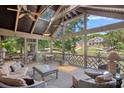 Spacious screened porch with comfortable seating, ceiling fans, and scenic views of the water at 5915 Mammoth Rd, Charlotte, NC 28270