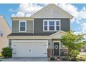 Charming two-story home with a manicured front yard, two car garage and beautiful stone accents at 6878 Spring Peeper Ln, Lancaster, SC 29720