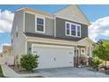 Charming two-story home with a manicured front yard, two car garage and beautiful stone accents at 6878 Spring Peeper Ln, Lancaster, SC 29720