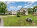 Nice view of a beautiful two-story house with a large front yard at 7031 Woodbridge Valley Cir, Charlotte, NC 28227