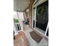 Inviting front porch with brick accents, a welcoming wreath, and outdoor seating at 715 Larimer Ln, Charlotte, NC 28262