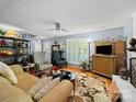 Spacious living room with hardwood floors, comfortable seating, a ceiling fan, and a fireplace offering a cozy atmosphere at 8017 Nathanael Greene Ln, Charlotte, NC 28227