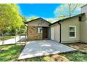 Spacious backyard featuring a concrete patio, partial brick wall and fenced yard at 8303 Hemby Wood Dr, Indian Trail, NC 28079