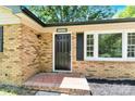 Inviting brick entryway leads to a classic black front door with decorative tiled landing at 8303 Hemby Wood Dr, Indian Trail, NC 28079