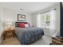 Cozy bedroom featuring natural light, a comfortable queen-sized bed, and stylish decor at 9204 Washam Potts Rd, Cornelius, NC 28031