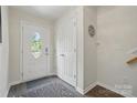 Bright entryway with hardwood floors, closet space, and a welcoming front door at 9204 Washam Potts Rd, Cornelius, NC 28031
