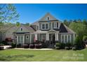 Charming home with manicured lawn, covered front porch, and American flag in a lovely, residential neighborhood at 1148 Wessington Manor Ln, Fort Mill, SC 29715