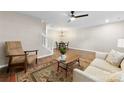Open living space with hardwood floors, ceiling fan, view to dining, and great natural light at 12536 Hennigan Place Ln, Charlotte, NC 28214