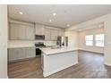 Modern kitchen with gray cabinets, stainless steel appliances, white backsplash, and island at 1326 31St St, Conover, NC 28613