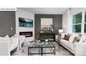 Modern living room with gray accent wall, fireplace, and stylish furniture at 134 Rustling Waters Dr, Mooresville, NC 28117