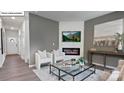 Contemporary living area featuring modern furnishings and a cozy fireplace at 134 Rustling Waters Dr, Mooresville, NC 28117