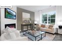 Bright living room with large window, modern furniture, and fireplace at 134 Rustling Waters Dr, Mooresville, NC 28117