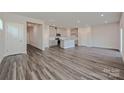 Open living space with plank flooring, connecting kitchen and dining area at 1350 31St St, Conover, NC 28613