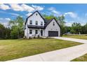 Beautiful two-story home with a stone and siding exterior, black accents, and a lush green lawn at 1500 Nectar Way # 32, Kannapolis, NC 28083