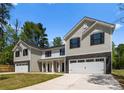 The home has light gray and white siding with stone accents, black shutters and a driveway at 1604 Breezewood Dr, Charlotte, NC 28262