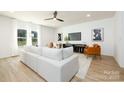 Modern living room with comfortable white sofa, stylish decor, and bright natural light at 1604 Breezewood Dr, Charlotte, NC 28262