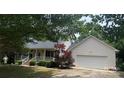 Ranch home featuring a covered front porch, attached two car garage, and beautiful landscaping at 165 Graceland Pl, Salisbury, NC 28146