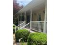 Front porch with white pillars, railing, and updated lighting for a welcoming curb appeal at 165 Graceland Pl, Salisbury, NC 28146