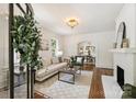 Bright living room featuring hardwood floors, fireplace, and arched doorway at 1804 Thomas Ave, Charlotte, NC 28205