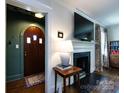 Elegant entryway featuring dark hardwood floors, and an arched wood doorway at 2033 Charlotte Dr, Charlotte, NC 28203
