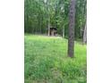 Rustic outbuilding in wooded area, great privacy; features include unique design and natural surroundings at 208 James Dr, Cleveland, NC 27013