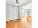 Bright entryway with gleaming hardwood floors, a white front door and fresh, neutral paint at 22330 Torrence Chapel Rd, Cornelius, NC 28031