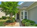 Charming front entrance with a decorative wreath, bay window, and tidy, trimmed landscaping at 23147 Whimbrel Cir, Fort Mill, SC 29707
